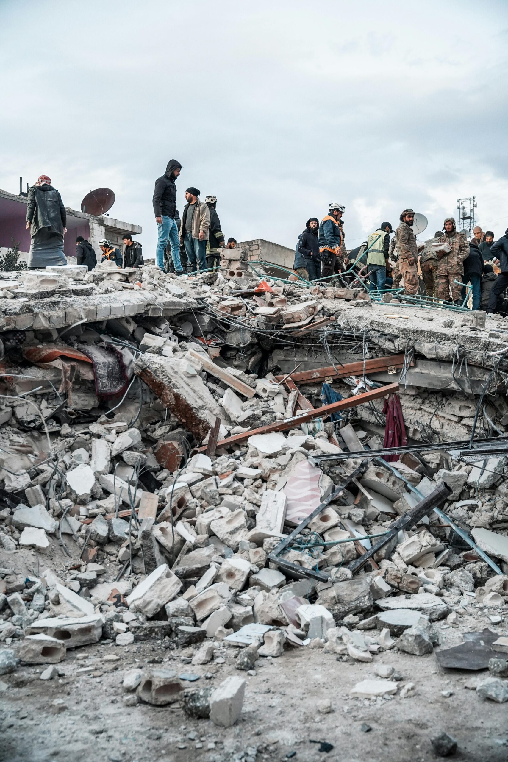 People inspect rubble after an earthquake in Jindires, Aleppo Governorate, Syria.